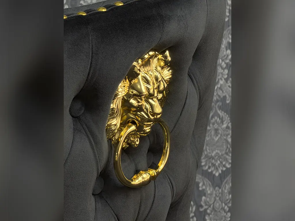 Goldener Löwenring an schwarzem Chesterfield Stuhl als Detailaufnahme in der Möbel Galerie Hamburg